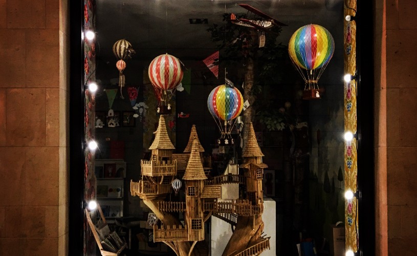 My Small World window display with tree house and hot air balloons